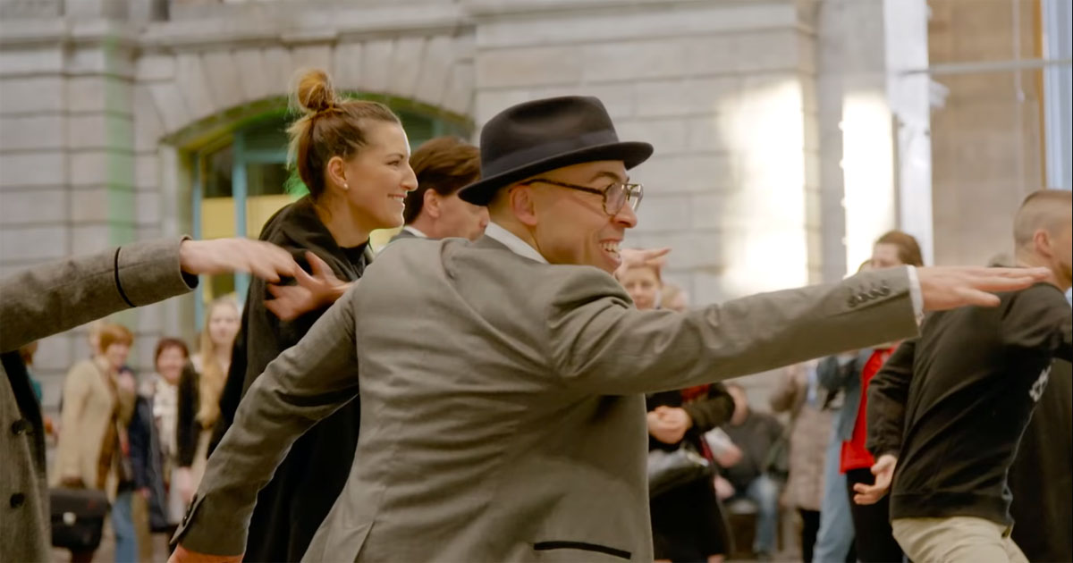 Crowd performs perfect Greasethemed flash mob in Belgian train station