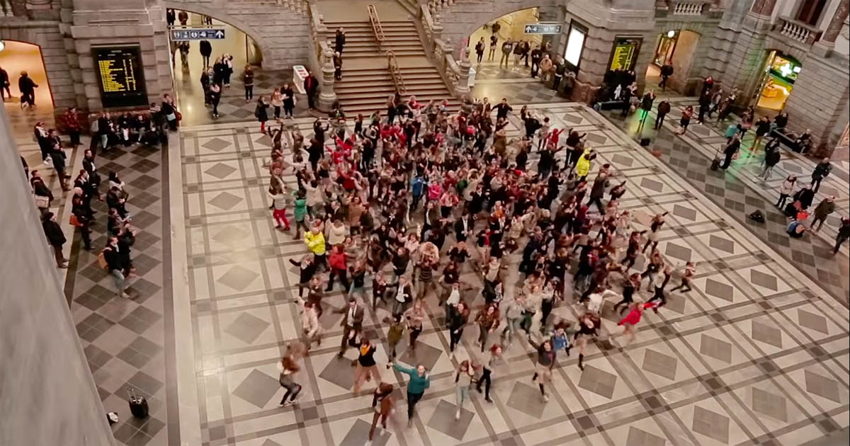 Crowd performs perfect Greasethemed flash mob in Belgian train station