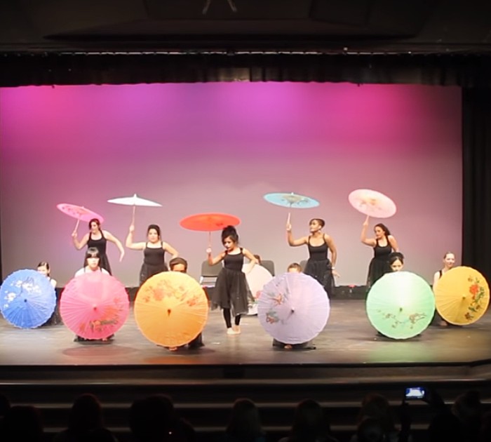 Twelve Young Woman Perform Mind Boggling Umbrella Dance