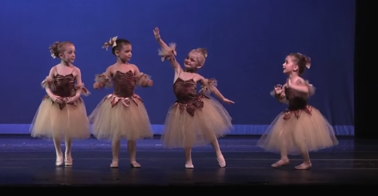Little girl falls during recital and quickly improvises